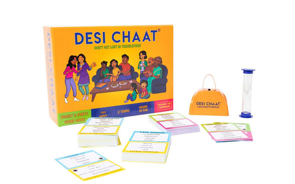 A yellow game box with cards and accessories in front of it